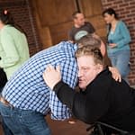 Decorative Image - Man hugging man in wheelchair
